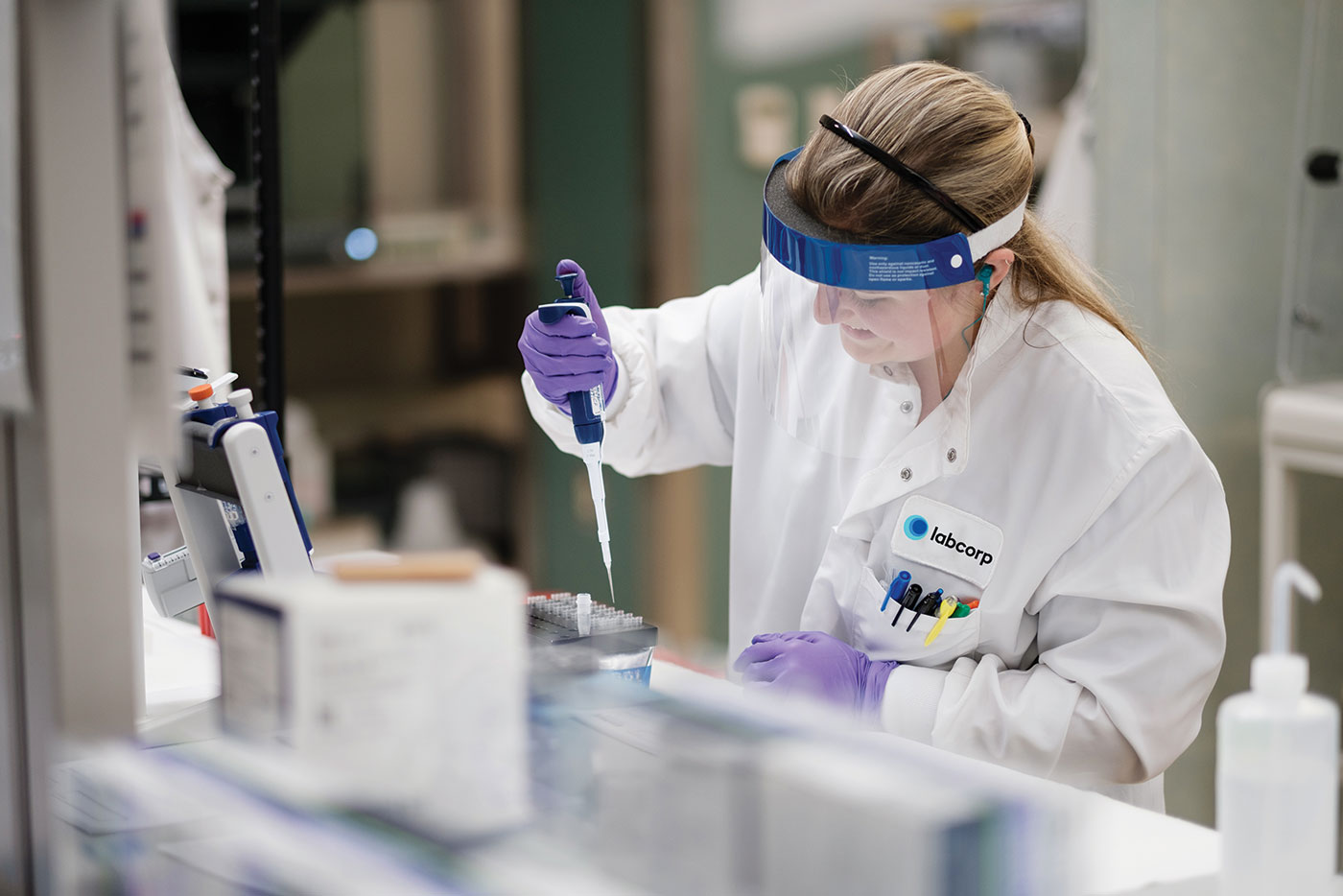Lab scientist working with precision equipment for supplement formulation